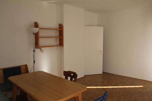 a dining room with a wooden table and a chair at Ferienhaus Vera in Obervellach