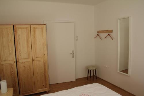 a bedroom with a bed and wooden cabinets at Ferienhaus Vera in Obervellach