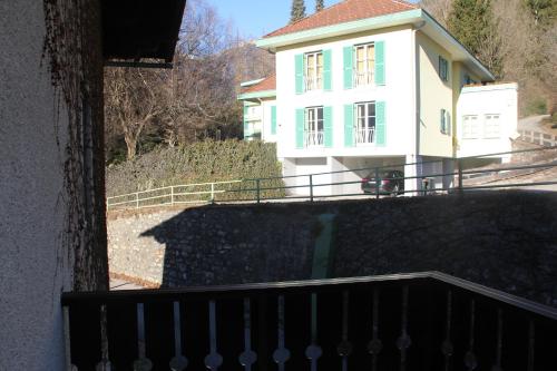 a white house with a shadow of a balcony at Ferienhaus Vera in Obervellach