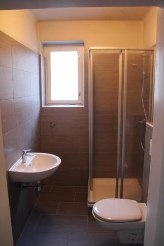 a bathroom with a toilet and a sink and a shower at Ferienhaus Vera in Obervellach
