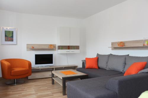 a living room with a couch and a tv at Zuhause auf Zeit Bielefeld in Bielefeld