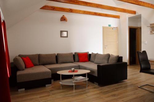 a living room with a couch and a table at Turistična Kmetija Čebelji Gradič in Rogašovci