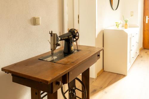 a sewing machine on a wooden table in a room at Ferienhaus - Großer Büchelstein in Grattersdorf