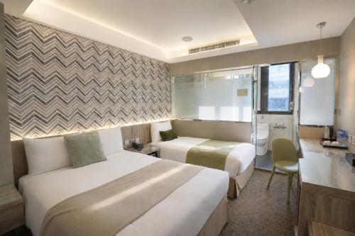 a hotel room with two beds and a bathroom at V-one Hotel - Ningxia No. 2 Inn in Taipei
