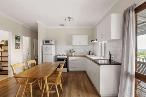 a kitchen and dining room with a table and chairs at Hillview - Spacious Bushland Haven with Resort Access in Yallingup