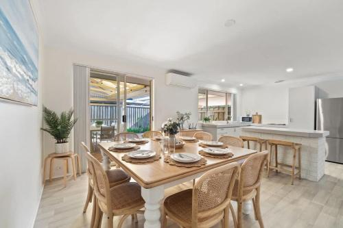 a kitchen and dining room with a table and chairs at Luna Getaway in Quindalup