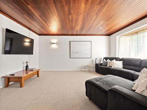 a living room with a couch and a table at Bluewater Retreat - Pet-Friendly Coastal Oasis in Broadwater