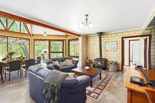 a living room with a couch and a table at Eagle Bay Beach Lodge - Escape to Coastal Serenity in Dunsborough