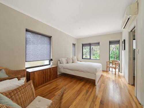 a bedroom with a bed and a living room at Rosella - Secluded Bushland Escape with Valley Views in Yallingup