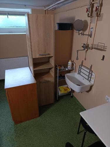 a small room with a sink and a table at Pokoje Gdańska in Żyrardów