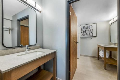a bathroom with a sink and a mirror at Days Inn by Wyndham Thunder Bay North in Thunder Bay