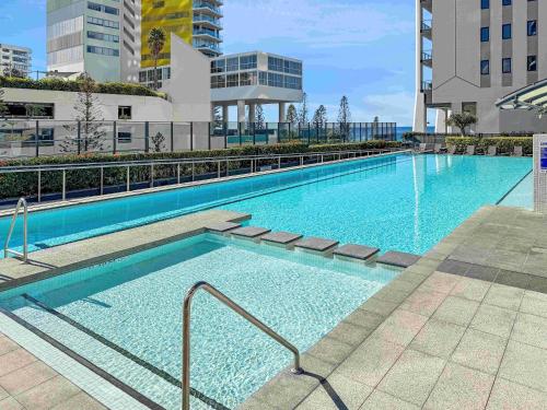 a large swimming pool with blue water in a building at Oracle Broadbeach Tower 1 Lvl 20 Free parking - GC Getaways in Gold Coast