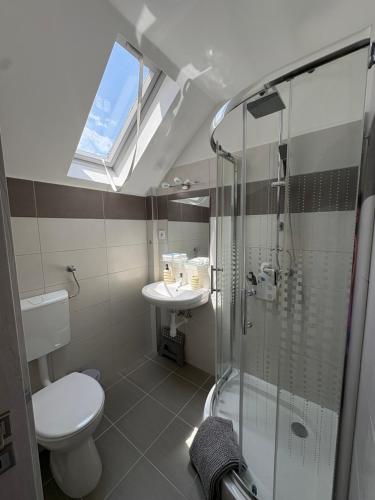a bathroom with a toilet and a sink and a shower at Villa Palma Balatonboglár in Balatonboglár