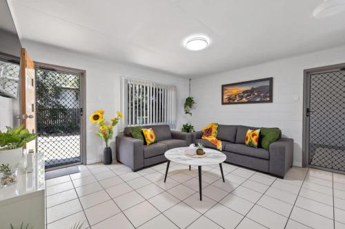 a living room with two couches and a table at Quiet & Comfortable with Wi-fi in Andergrove
