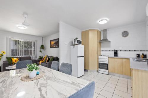 a kitchen and a living room with a counter top at Quiet & Comfortable with Wi-fi in Andergrove