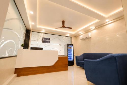 a waiting room with two blue chairs and a table at Hotel SSV Suites Premium Near HItech City, Madhapur in Hyderabad