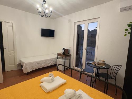 a room with a bed and a table with towels at Il Casale dei Calanchi in Aliano