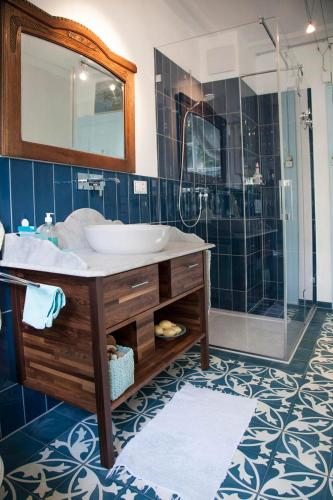 a bathroom with a sink and a shower at BnB villaSteiner in Birrwil