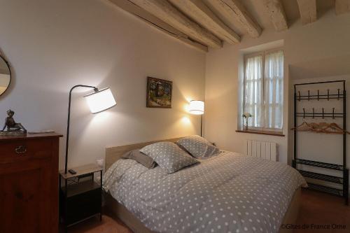 a bedroom with a bed with two pillows on it at Gîtes de france le cosy saint pierre in Sées