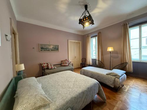 a bedroom with two beds and a chandelier at B7 Hostal in Trieste