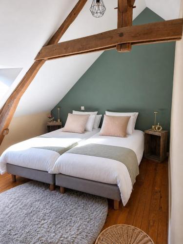 two beds in a room with a attic at Chez Sam et Brice in Saint-Georges-Buttavent