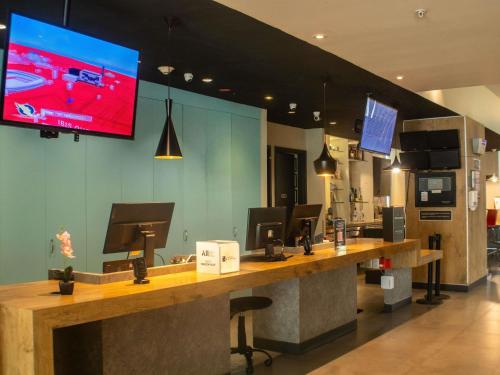 a large tv on the wall of a store at Ibis Mexico Alameda in Mexico City