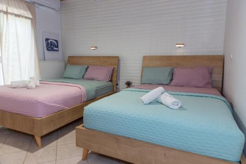 two beds sitting next to each other in a room at rosalena's house in Chalkida