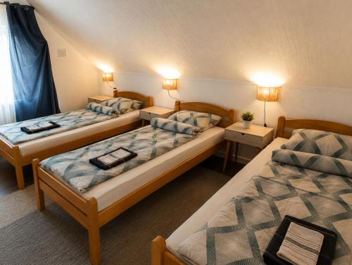 two beds in a room with two tables and two lamps at Holiday Home Alen - Una National Park Retreat - with Garden & Terrace in Kulen Vakuf