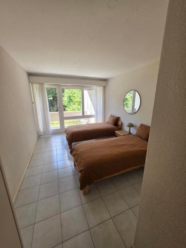 a bedroom with two beds and a window at Appartement 188m2 in Crans-Montana