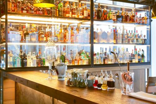 a bar with a lot of bottles of alcohol at Novotel London Canary Wharf in London