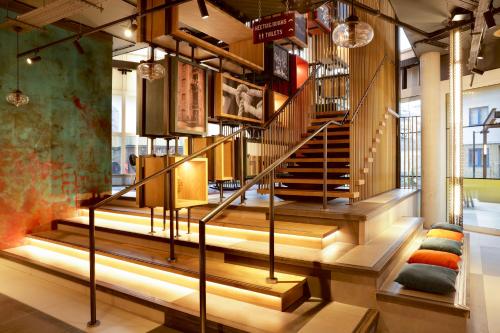 a staircase in a building with lights at Novotel London Canary Wharf in London