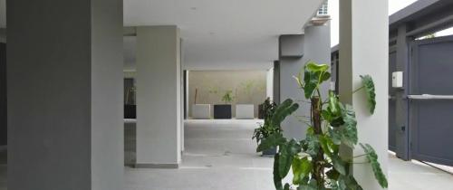 a hallway with a potted plant in a building at Résidences Aya in Abidjan
