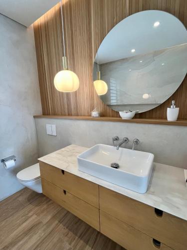 a bathroom with a sink and a mirror at Breathtaking seaview penthouse - Belle Mare in Post of Flacq