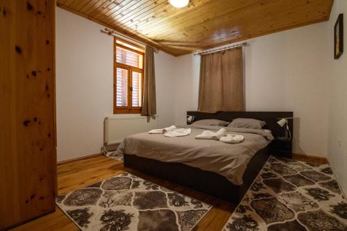 a bedroom with a bed with two towels on it at Вила Рай in Elena