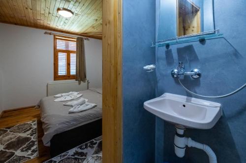a bathroom with a sink and a bed in a room at Вила Рай in Elena