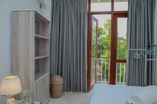 a bedroom with a bed and a large window at Aranya Heights Luxury 7 Pax Home in Wattala