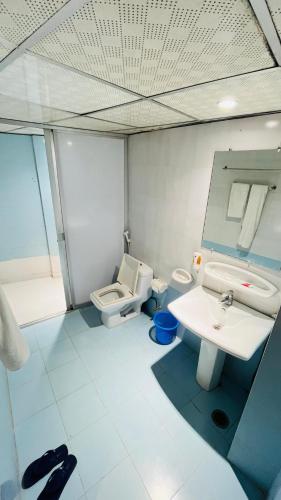 a bathroom with a toilet and a sink at Praasad Paradise in Cox's Bazar