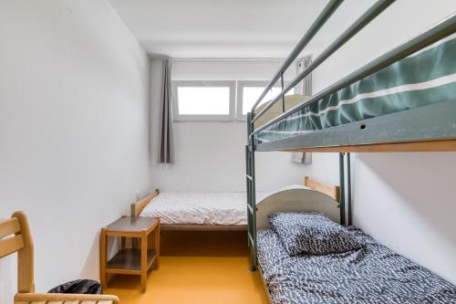 a room with two bunk beds and a staircase at Résidence Arkenciel 1 in Mudaison