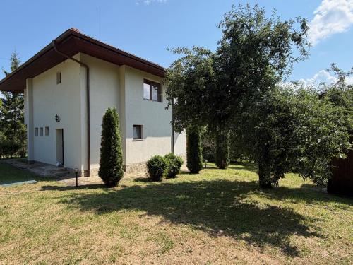 a white house with trees in front of it at The Old Walnut House in Terziysko