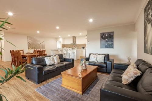 a living room with two couches and a coffee table at Cockatoo Lodge - Winery Retreat at Rivendell Estate in Yallingup Siding