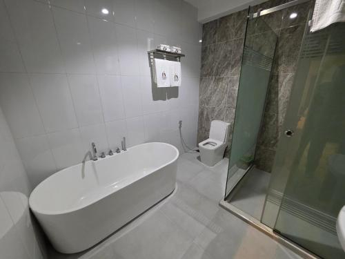 a bathroom with a sink and a shower and a toilet at Movela Hotels in Warri