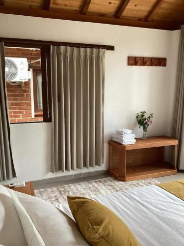 a bedroom with a bed and a window with blinds at LAS 7 CASCADAS Campground - Restaurant - Lodge in Cacaoal