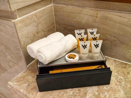 a box with a towel and vases in a bathroom at SureStay by Best Western in Cox's Bazar