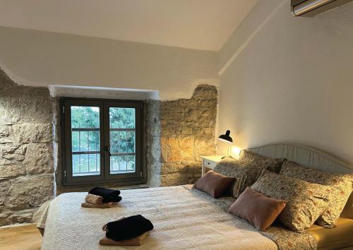 a bedroom with a bed with two hats on it at Villa Olmeto in Lupoglav