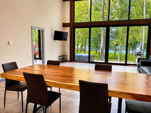 a large wooden table in a room with chairs at 3-bedroom Lakefront Villa #5 in Lakefield