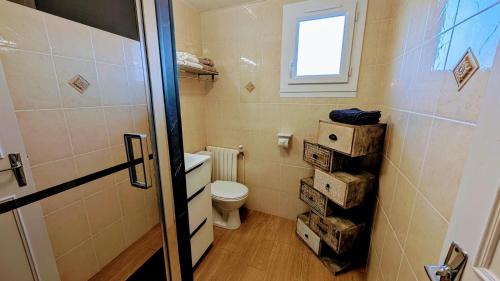 a small bathroom with a toilet and a window at Villetelle in Cheissoux