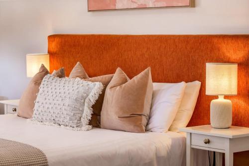 a bedroom with a bed with pillows and two lamps at Lana Unit 31 Studio Apartment - Central Base for South West Adventures in Margaret River Town