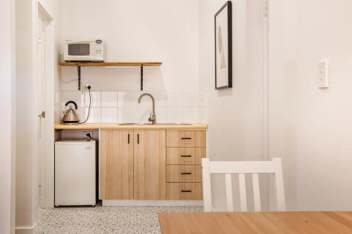 a small kitchen with a sink and a refrigerator at Lana Unit 31 Studio Apartment - Central Base for South West Adventures in Margaret River Town