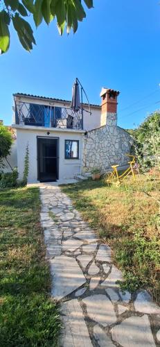a stone path in front of a house at Filich Home Experience in Labin