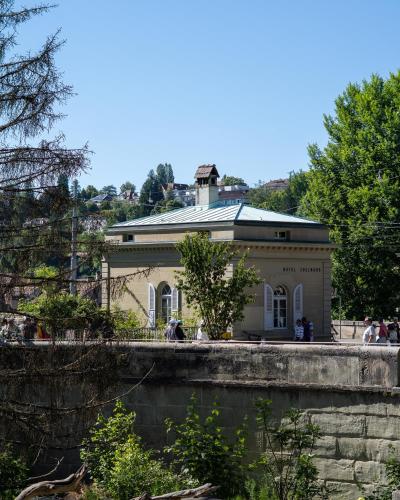 a building with people standing in front of it at One Suite Hotel - Zollhaus in Bern